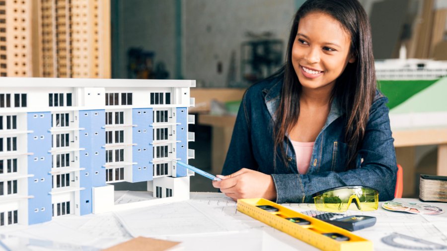 smiling-african-american-woman-showing-model-building