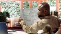 Small business owner analyzing architectural sketches and planning office spaces, focusing on blueprint review and strategic layout design. Evaluating property for modern and professional workspace.